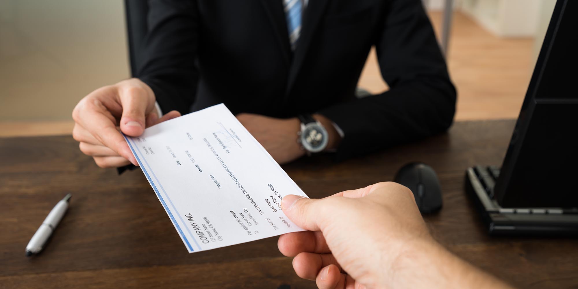 Person Handing Out a Check